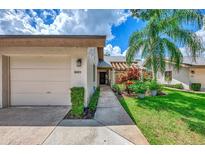 Exterior view of condo with garage and landscaped walkway at 4521 Kingsmere # 6, Sarasota, FL 34235