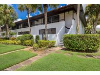 Two-story condo building with lush landscaping at 3500 El Conquistador Pkwy # 238, Bradenton, FL 34210
