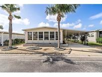Charming single-wide manufactured home with carport and landscaping at 3410 Spanish Oak Ter, Sarasota, FL 34237
