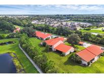Scenic aerial view of a charming community with well-maintained landscaping and tranquil ponds at 6384 Draw Ln # 38, Sarasota, FL 34238