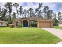 Tan one-story house with teal door and landscaped lawn at 3165 Stokie Ave, North Port, FL 34286