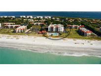 An aerial view of a condo complex located directly on a beautiful white sand beach at 1945 Gulf Of Mexico Dr # M2-310, Longboat Key, FL 34228