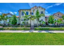 Beautiful two-story house with lush landscaping and gated entrance at 906 E Venice Ave, Venice, FL 34285