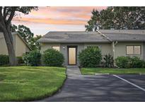 Exterior view of a condo unit with a landscaped yard and parking at 2708 60Th Avenue W Ter # A, Bradenton, FL 34207