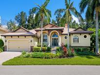 Beautiful two-story home with tile roof and landscaped yard at 12313 Baypointe Ter, Cortez, FL 34215