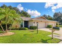 Well-maintained single-story home with lush landscaping and a two-car garage at 3541 Wilkinson Woods Dr # 40, Sarasota, FL 34231