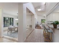 Open-concept interior view showcasing the dining area, hallway, and kitchen with bright, natural light at 3601 Quail Hollow Ln, Bradenton, FL 34210