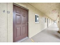 Apartment hallway with brown doors and light colored walls at 3777 Lake Bayshore Dr # H401, Bradenton, FL 34205