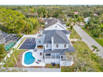 Stunning aerial view showcasing a home with a pool and basketball court at 3811 Bayside Cir, Bradenton, FL 34210