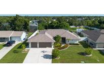 Single-Gathering home with a three-car garage and landscaped yard at 10268 Alexandria Ave, Englewood, FL 34224