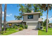 Two-story home with brick driveway and landscaping at 2631 Fiesta Dr, Venice, FL 34293