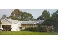 One-story house with attached garage and yard at 27373 Sandrala Dr, Punta Gorda, FL 33955