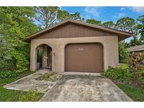 Tan house with brown roof and garage at 1862 Rita St, Sarasota, FL 34231