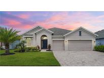 Attractive one-story home with a two-car garage and landscaped front yard at 5712 Hevena Ct, Palmetto, FL 34221