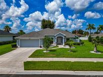 Single-Gathering home with two-car garage and landscaped yard at 2289 Charleston Park Dr, North Port, FL 34287