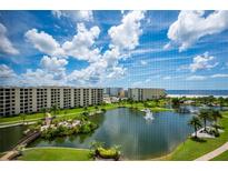 Stunning view of a resort-style pool and ocean from a condo at 5760 Midnight Pass Rd # 702, Sarasota, FL 34242