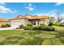 Attractive single-story home with well-manicured lawn and attached garage at 4995 Pepperwood Pl, Venice, FL 34293