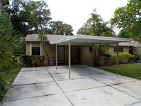 Tan house with carport and landscaped yard at 4973 Village Gardens Dr # 50, Sarasota, FL 34234