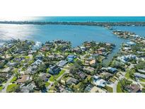 Aerial view of waterfront property with lush landscaping and private dock at 1833 Sandalwood Dr, Sarasota, FL 34231