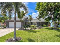 House exterior featuring a two-car garage and lush landscaping at 7907 24Th W Ave, Bradenton, FL 34209