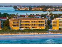 Aerial view of beachfront condo building with stunning ocean views at sunset at 1900 Gulf N Dr # 1, Bradenton Beach, FL 34217