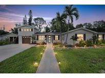 Two story home with landscaped yard, walkway, and updated exterior at 303 48Th W St, Bradenton, FL 34209