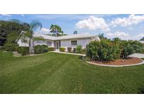 Single-story home with landscaped yard and two-car garage at 3653 Bonaventure Ct, Sarasota, FL 34243