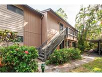Exterior view showing stairs to condo entrance and landscaping at 1700 Glenhouse Dr # 406, Sarasota, FL 34231