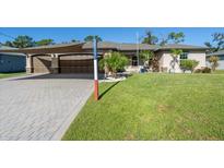 Two-story home with a two-car garage and well-manicured lawn at 4457 Maywood Ln, North Port, FL 34286