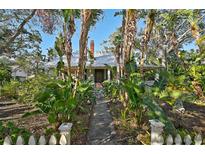 Charming house with lush tropical landscaping and a brick pathway at 1663 4Th St, Sarasota, FL 34236