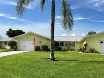 Charming yellow home with a well-maintained lawn and garage at 6812 11Th W Ave # 6812, Bradenton, FL 34209