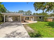 Ranch style home with carport and landscaped yard at 5413 Capitan Ave, Sarasota, FL 34235