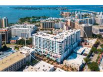Aerial view of a modern building with city and water views at 111 S Pineapple Ave # 1009, Sarasota, FL 34236