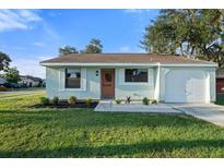 Newly renovated light teal single story home with attached garage at 19584 Kapok Ct, Port Charlotte, FL 33952