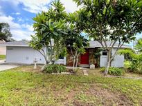 Single story home with red door and landscaping at 20437 Midway Blvd, Port Charlotte, FL 33952