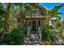 Charming bungalow with lush landscaping and a welcoming porch at 1677 4Th St, Sarasota, FL 34236