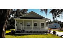 Craftsman style home with front porch and well manicured lawn at 710 N Thomas St, Plant City, FL 33563