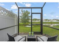 Screened porch overlooking a pond and community at 4119 Via Sienna Cir, Sarasota, FL 34243