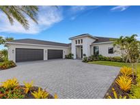 Luxury home with three-car garage and landscaped yard at 9004 Artisan Way, Sarasota, FL 34240