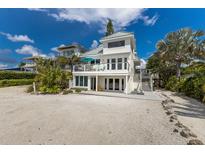 Beautiful beach house with a light exterior, spacious balcony, and beachfront access at 3007 Avenue F # 1, Holmes Beach, FL 34217