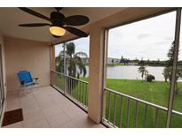Relaxing screened balcony with a ceiling fan and a lovely lake view at 3807 Lake Bayshore Dr # H-416, Bradenton, FL 34205