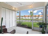 Enjoy the screened lanai with string lights and pond views, perfect for relaxing outdoors at 4224 Madeira Ct # 3309, Sarasota, FL 34233