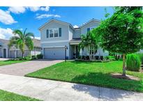 Two-story house with gray siding and a landscaped yard at 3360 Chestertown Loop, Bradenton, FL 34211