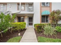 Front entry of condo with landscaped walkway and plants at 4224 Madeira Ct # 3309, Sarasota, FL 34233