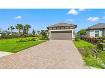New home with attached garage and landscaped yard at 3118 Tramonto Ct, Bradenton, FL 34211