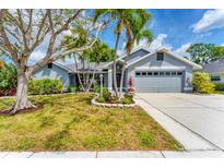 Charming single-story home featuring a well-manicured lawn, lush landscaping, and a two-car garage at 5306 19Th W Ave, Bradenton, FL 34209