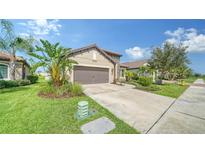 Single-story home with attached garage and nicely landscaped front yard at 220 Capriana Ct, Nokomis, FL 34275