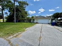 Single-story home with a white garage door and driveway at 361 Porpoise Rd, Venice, FL 34293