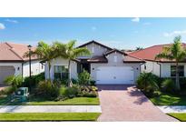 House exterior with a brick driveway and landscaping at 341 Villoresi Blvd, Nokomis, FL 34275