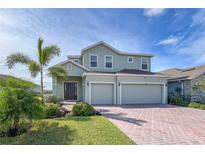 Two-story house with a two-car garage and landscaping at 11671 Little River Way, Parrish, FL 34219